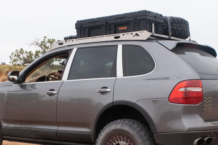 Sherpa Equipment Co. roof rack mounted on a Porsche Cayenne with overlanding gear